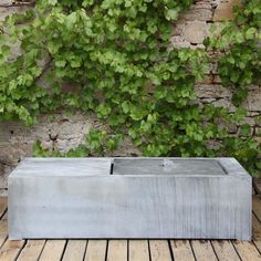 a concrete box sitting on top of a wooden floor