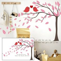 a tree with pink leaves and two birds sitting on top of it, next to a wall decal that says i can only love you one