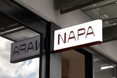 a sign that says napa hanging from the side of a building next to a window