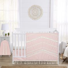 a crib bedding set with pink and white stripes