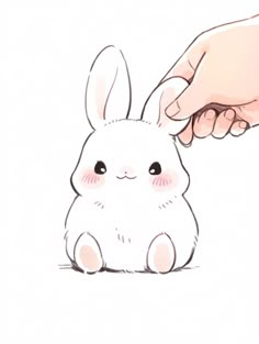 a drawing of a hand reaching for a small white bunny