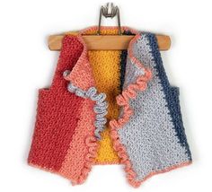 three crocheted towels hanging on a wooden hanger