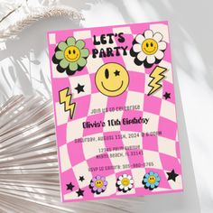 a pink and white checkered birthday party card with smiley face on it, surrounded by flowers