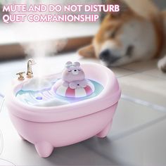 a dog laying on the floor next to a pink bath tub with a cartoon character in it