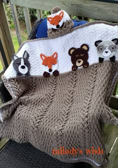 there is a crocheted blanket with animals on it