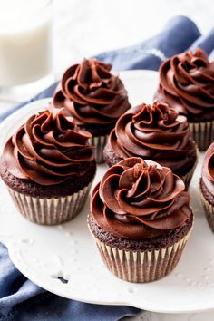 chocolate cupcakes with frosting on a white plate