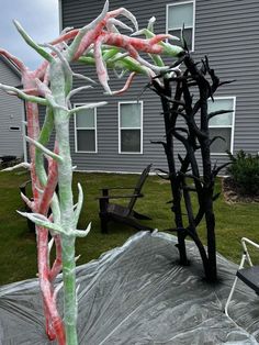 an outdoor sculpture made out of sticks and plastic wrap