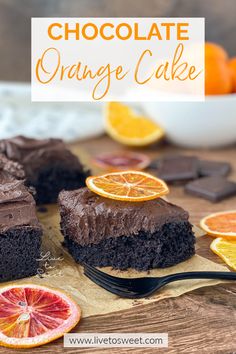 chocolate orange cake on a cutting board with sliced oranges