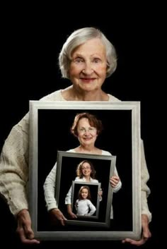 an old woman holding up a framed photo with the words in arabic and english on it