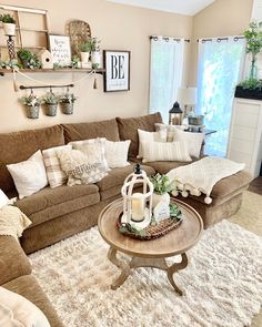 a living room filled with lots of furniture and decor on top of a white rug