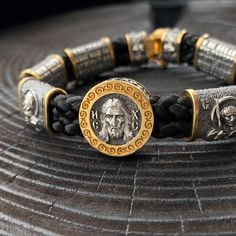 About this item.Orthodox Christian bracelet.Braided leather cord in alloy with inserts depicting saints.Total weight approx. 53 grams.✔️ Round center inlaid with an image of Jesus Christ and the prayer “Save and Protect”.On the reverse side of the Eucharist.✔️ Alloy textured inserts, and images of saints:Image of Our Lady of Kazan,Our Lady of Moscow.Our Lady of the Seven Guns,Sergei Radonezhsky.Nicholas the Miracle WorkerGeorge the VictoriousBracelet measures 3.14 inches in diameterOverall lengt Orthodox Jesus, Image Of Jesus, The Eucharist, The Prayer, Jesus Images, Eucharist, Woven Bracelets, Kazan, Braided Leather