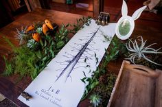 the table is covered with plants and paper