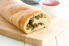 a close up of a bread roll on a cutting board