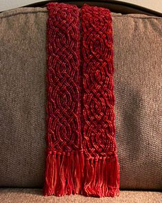 a red scarf sitting on top of a couch