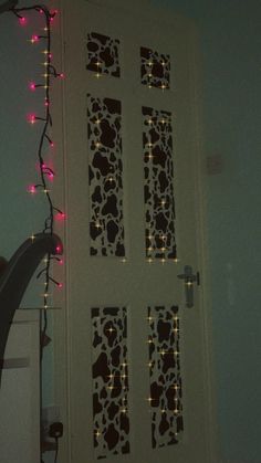 the door is decorated with christmas lights and decorative designs on it's side wall