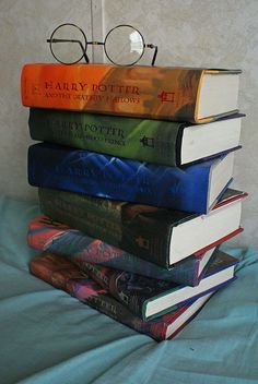 a stack of books with glasses on top