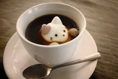 a cup of coffee with a hello kitty in it