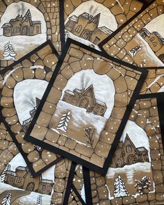 several pieces of art that have been made to look like houses in the snow with trees on them