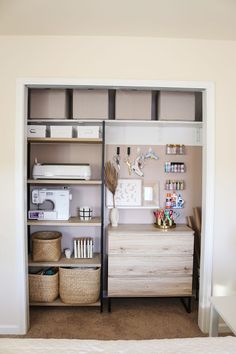 an open closet with shelves, baskets and sewing machines on it's sides in a bedroom