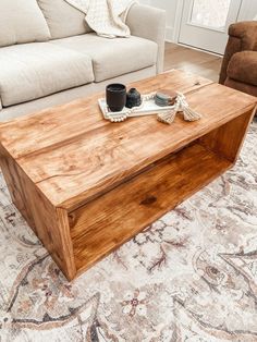 a wooden coffee table sitting on top of a rug