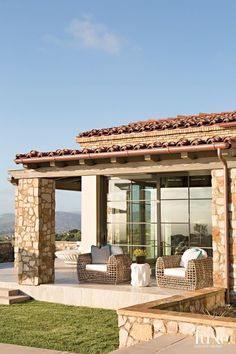 an outdoor living area with chairs and tables