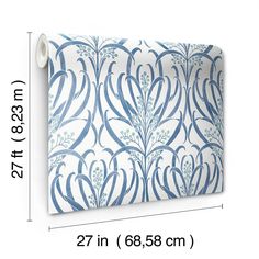 a blue and white wallpaper with an ornate design on it's side, next to a ruler