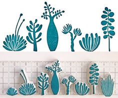 several blue vases and plants on a ruler