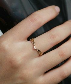 a close up of a person's hand with a ring on it