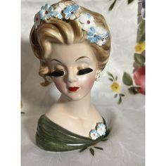 a ceramic busturine with flowers in her hair