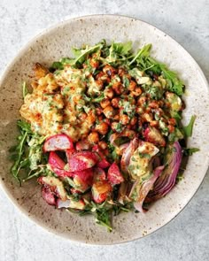 a white bowl filled with salad on top of a table