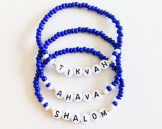 "**We have donated over $49,000 to various organizations since the summer of 2020. Thank you High-quality Czech glass royal blue and white beads, with silver glass accents. Select \"Shalom\" (peace), \"Tikvah\" (hope) or \"Ahava\" (love). **If you want all three bracelets as pictured, please select \"Set of 3\" from the drop-down. Otherwise you will only receive ONE bracelet as selected.** We can use gold accents if you prefer--just be sure to add that to the notes section when you check out, an Hebrew Bracelet, Simon Wiesenthal, White Beads Bracelet, Clay Bead, Different Words, Silver Glass, Minimalist Bracelet, Bead Bracelets, Name Bracelet