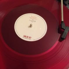 a red record player sitting on top of a table