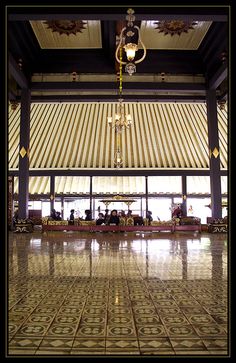 the inside of a building with tile flooring and chandelier hanging from the ceiling