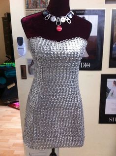 a mannequin is covered in silver chain mail