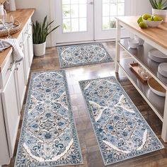 three rugs in the middle of a kitchen with plates and bowls on the counter