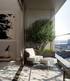 a balcony with white furniture and a painting on the wall