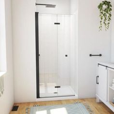 a bathroom with a shower, sink and rug on the floor in front of it