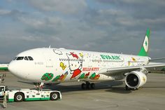 an airplane with hello kitty painted on it's side is parked at the airport