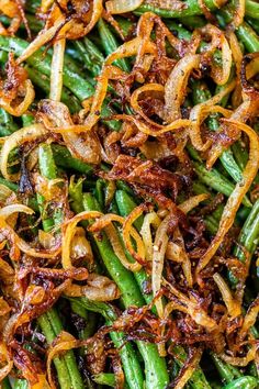 green beans and onions are mixed together in a dish that is ready to be eaten