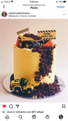 there is a cake with construction trucks on it and dirt in the bottom tiers