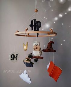 a mobile with an owl and other items hanging from it