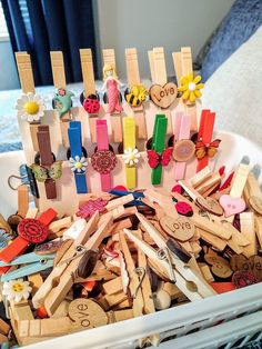 a basket filled with lots of wooden clothes pins and ties on top of a table