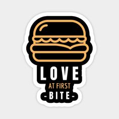 a black and yellow sticker with the words love at first bite