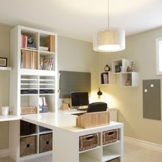 a home office with white shelves and drawers