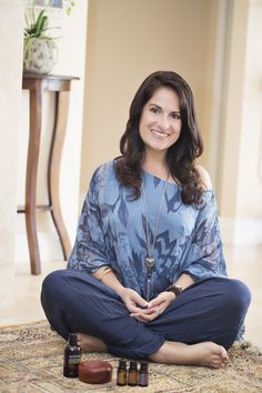 a woman is sitting on the floor with her feet crossed