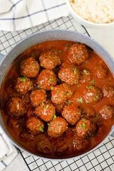 meatballs and gravy in a pot next to rice