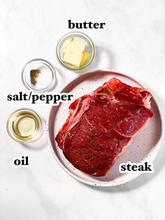 raw meat on a white plate with ingredients labeled in the words salt, pepper, and steak