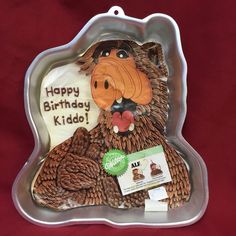 a cake in the shape of a bear with a happy birthday card