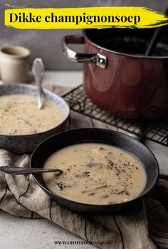 two bowls filled with soup on top of a table