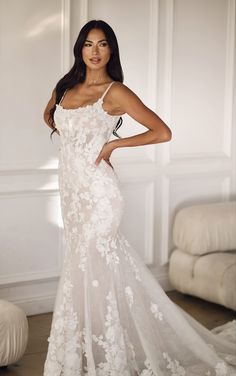 a woman in a wedding dress posing for the camera